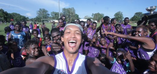 Irawan posing in front of the Tikaliru Dockers Tiwi Islands AFL Grand Final 2018