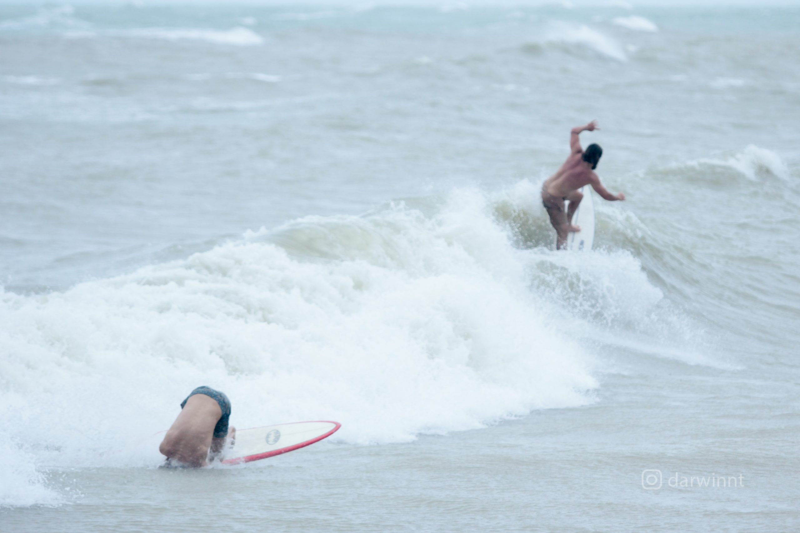 Nightcliff surfer during wet season stormy weather no crocodile will stop them